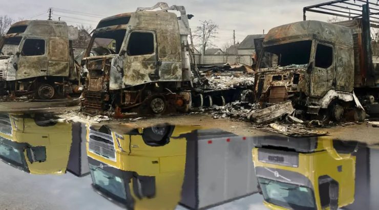 Burned trucks parked beside a puddle near the Good Wine warehouse.